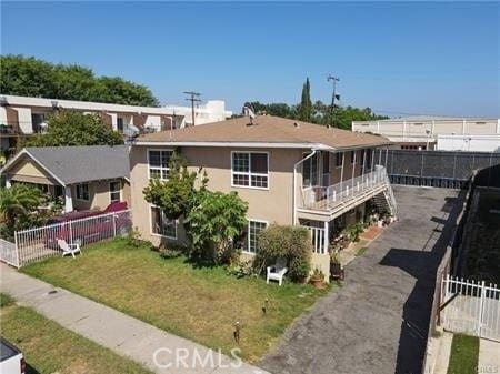 315 S Garnsey St, Santa Ana, CA 92701 - exterior space with a lawn, stucco siding, and fence