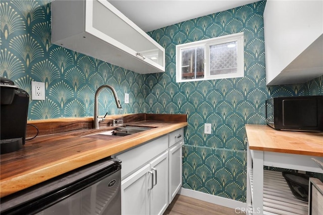 4338 Beagle St, Los Angeles, CA 90032 - kitchen featuring wallpapered walls, dishwashing machine, black microwave, white cabinets, and butcher block counters