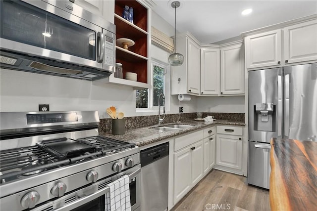 4338 Beagle St, Los Angeles, CA 90032 - kitchen with stainless steel appliances, a sink, light wood-style flooring, and white cabinets