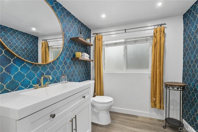 4338 Beagle St, Los Angeles, CA 90032 - bathroom featuring wallpapered walls, wood finished floors, toilet, vanity, and recessed lighting