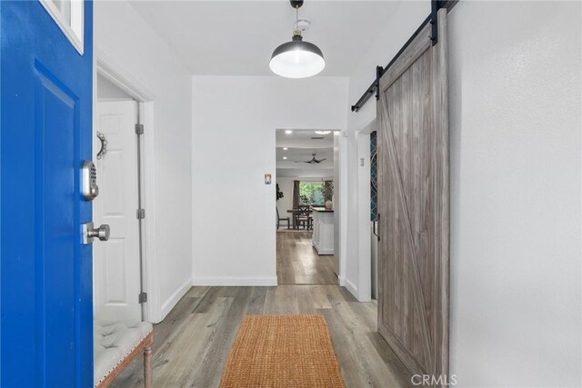 4338 Beagle St, Los Angeles, CA 90032 - entryway with a barn door, wood finished floors, and baseboards