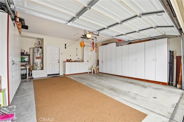 garage featuring a garage door opener and secured water heater
