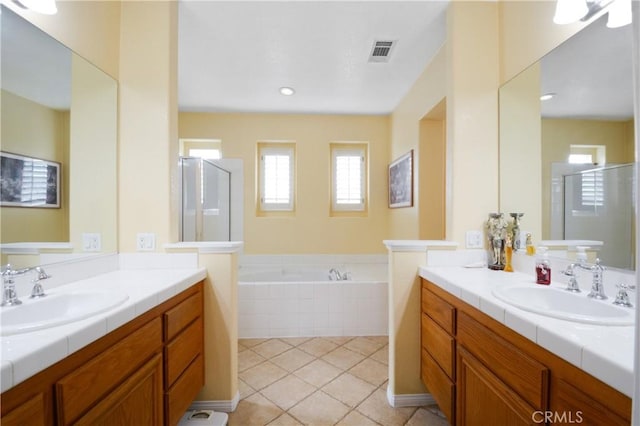 full bathroom with visible vents, a stall shower, and a sink