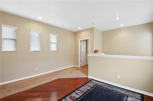 carpeted entryway featuring recessed lighting and baseboards