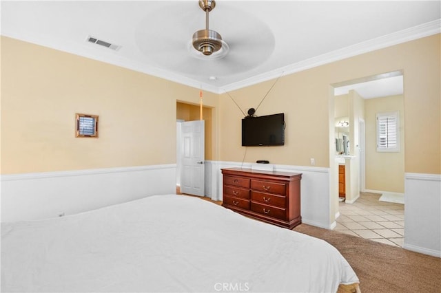 bedroom with crown molding, a ceiling fan, visible vents, and light colored carpet