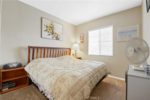 bedroom with baseboards and carpet
