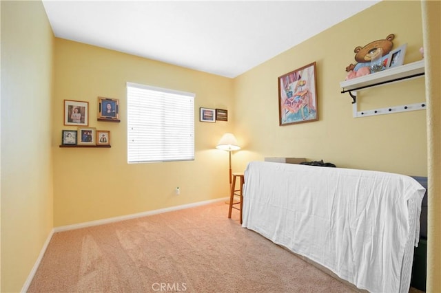 bedroom featuring carpet and baseboards