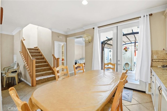 dining room with stairway, light tile patterned floors, baseboards, ornamental molding, and french doors