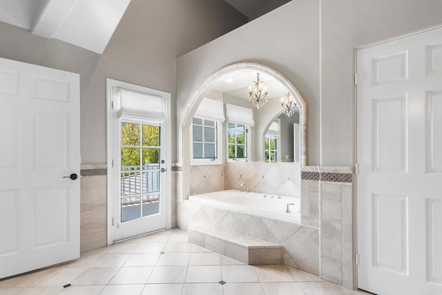 5135 Island Forest Pl, Westlake Village, CA 91362 - bathroom featuring an inviting chandelier, a garden tub, lofted ceiling, tile patterned floors, and a wainscoted wall