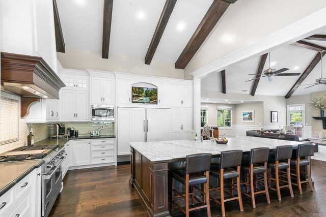 5135 Island Forest Pl, Westlake Village, CA 91362 - kitchen with beam ceiling, light stone countertops, open floor plan, tasteful backsplash, and appliances with stainless steel finishes