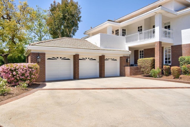 5135 Island Forest Pl, Westlake Village, CA 91362 - view of front facade featuring brick siding, an attached garage, stucco siding, and concrete driveway