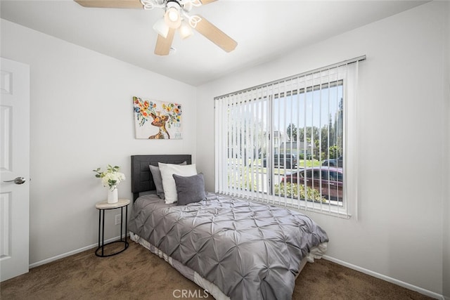 carpeted bedroom featuring baseboards and a ceiling fan