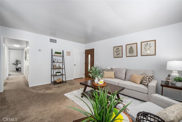carpeted living room featuring visible vents and baseboards
