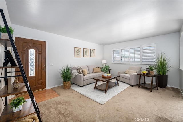 living area featuring baseboards and light carpet