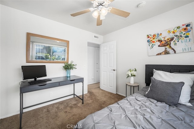 carpeted bedroom with baseboards, a ceiling fan, and visible vents