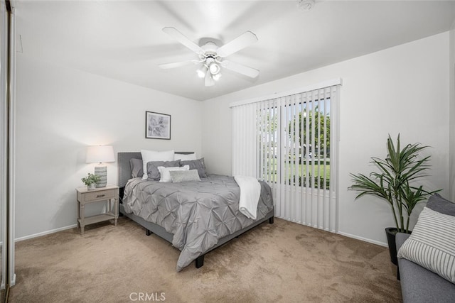 bedroom featuring carpet floors, baseboards, and ceiling fan