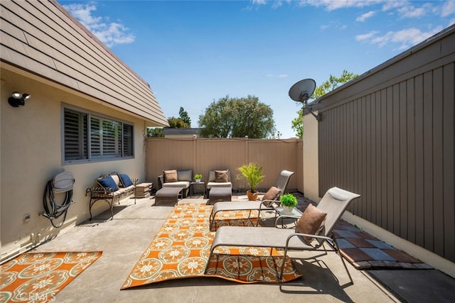 view of patio with an outdoor hangout area and fence