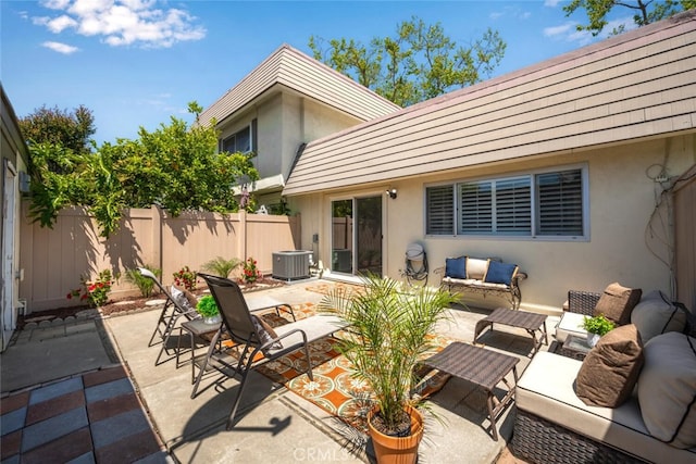 view of patio / terrace with central air condition unit, fence, and an outdoor hangout area