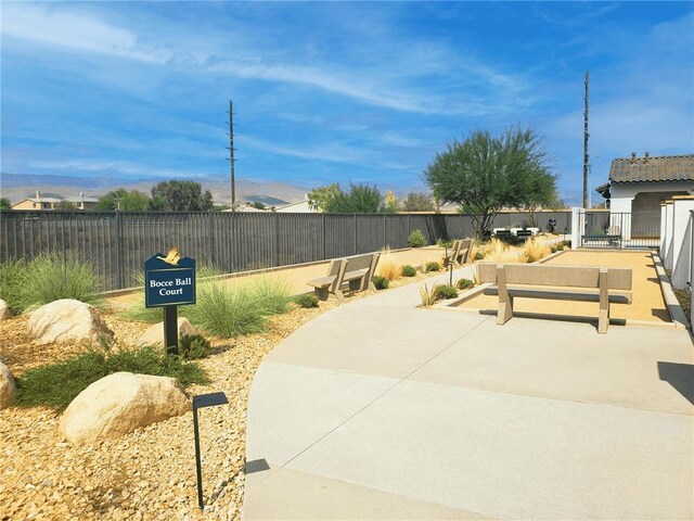 view of patio / terrace featuring a mountain view and fence