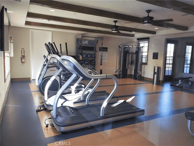 workout area featuring ceiling fan and baseboards