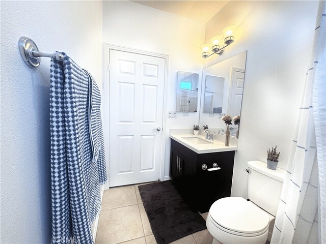 bathroom featuring toilet, vanity, and tile patterned floors
