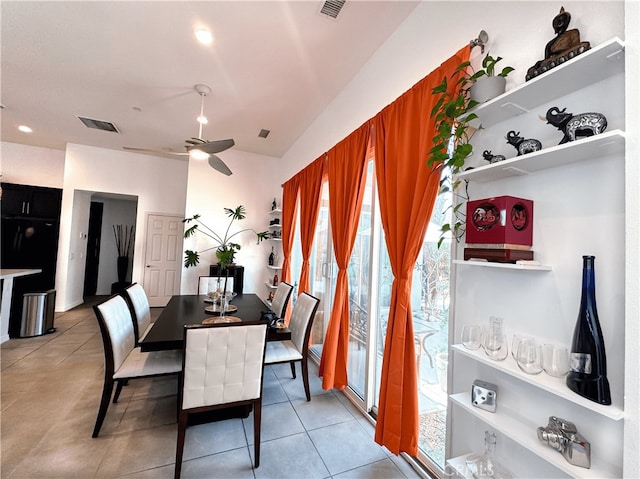 dining room with visible vents, light tile patterned floors, a ceiling fan, and vaulted ceiling