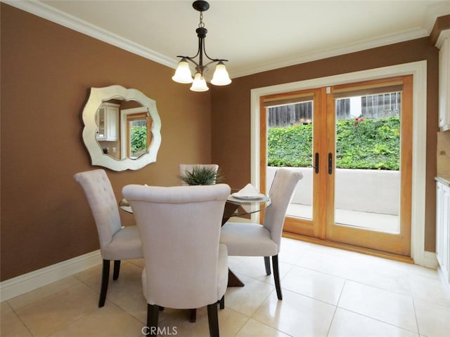 dining room featuring an inviting chandelier, french doors, ornamental molding, and baseboards