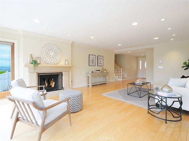 4911 Browndeer Ln, Rancho Palos Verdes, CA 90275 - living area featuring stairs, crown molding, recessed lighting, light wood-style floors, and a warm lit fireplace