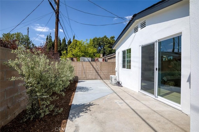 view of patio with a fenced backyard and ac unit