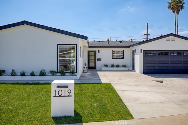 single story home featuring an attached garage, stucco siding, driveway, and a front yard