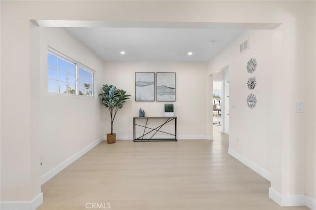 corridor with baseboards, recessed lighting, light wood-style flooring, and visible vents