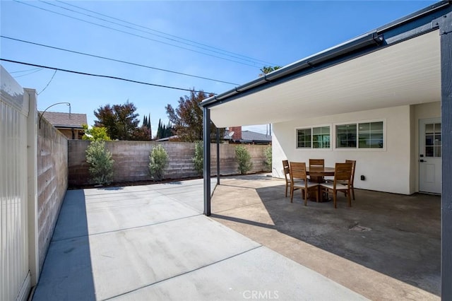 view of patio featuring outdoor dining area and a fenced backyard