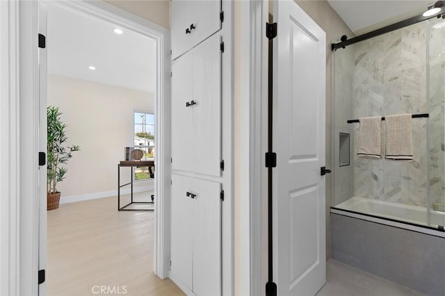full bathroom with baseboards, recessed lighting, wood finished floors, and shower / bath combination with glass door
