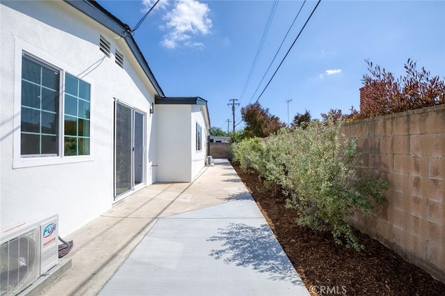 view of home's exterior with a patio, a fenced backyard, ac unit, and stucco siding