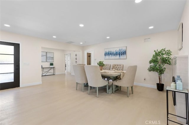 dining area with recessed lighting, baseboards, visible vents, and light wood-type flooring