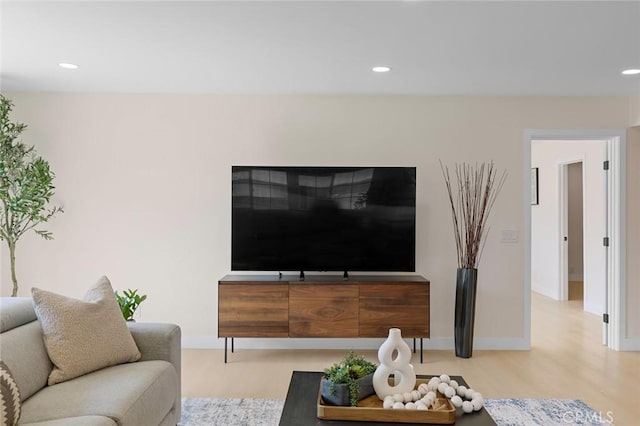 living room featuring recessed lighting, baseboards, and wood finished floors