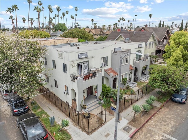 view of building exterior with a residential view and a fenced front yard