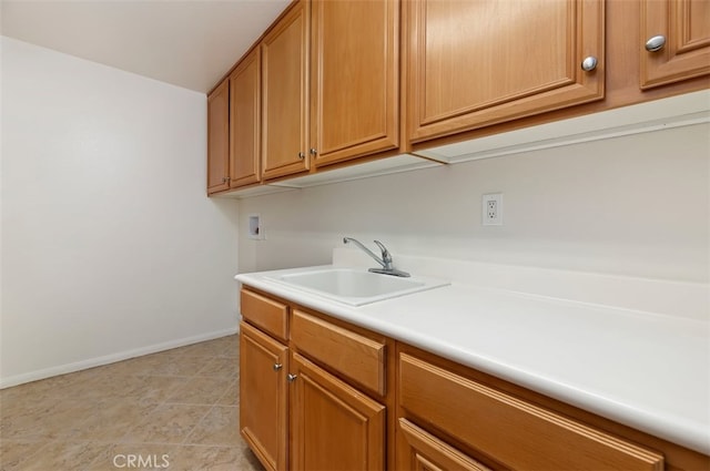 29855 Bay View Way, Menifee, CA 92584 - clothes washing area featuring hookup for a washing machine, baseboards, cabinet space, and a sink
