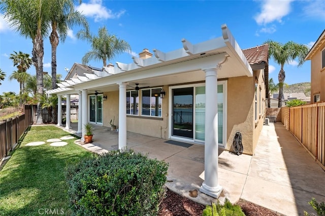 29855 Bay View Way, Menifee, CA 92584 - back of house featuring a lawn, ceiling fan, stucco siding, and a fenced backyard