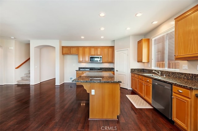 29855 Bay View Way, Menifee, CA 92584 - kitchen featuring dark stone counters, a center island, appliances with stainless steel finishes, and a sink