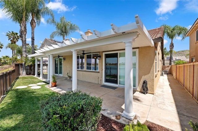 29855 Bay View Way, Menifee, CA 92584 - back of property featuring a yard, ceiling fan, stucco siding, and a fenced backyard
