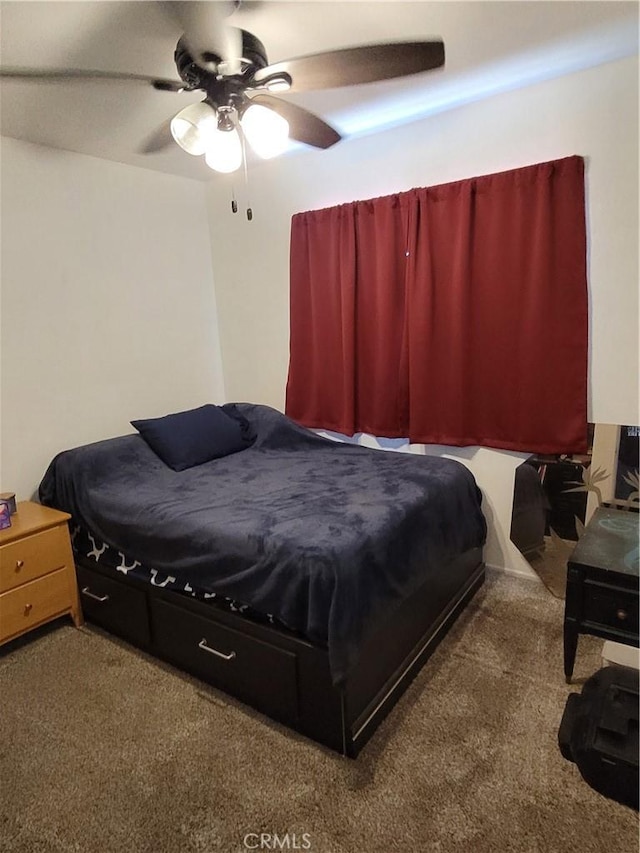 bedroom with a ceiling fan and carpet floors