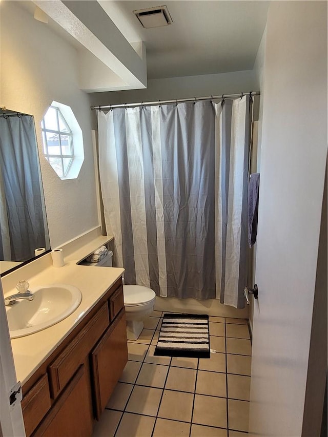 bathroom with a shower with curtain, visible vents, toilet, vanity, and tile patterned flooring