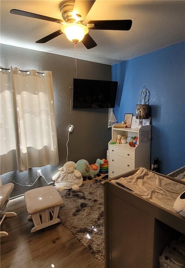 bedroom featuring wood finished floors and ceiling fan