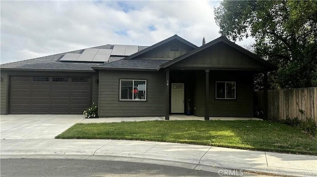 16 Petaluma Ct, Chico, CA 95926 - view of front of house featuring a garage, solar panels, driveway, board and batten siding, and roof with shingles