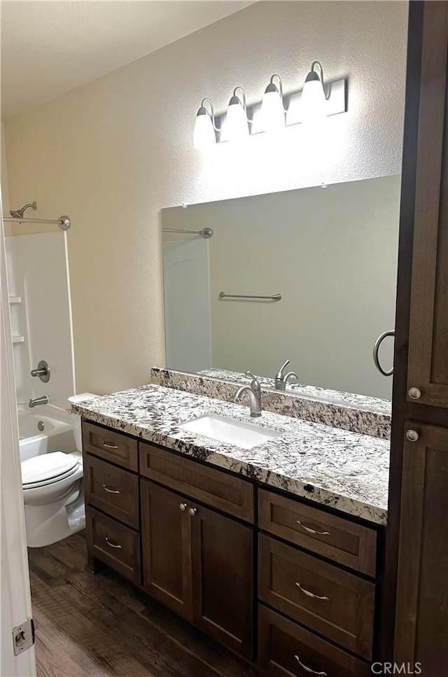 16 Petaluma Ct, Chico, CA 95926 - bathroom featuring wood finished floors, vanity, toilet, and tub / shower combination