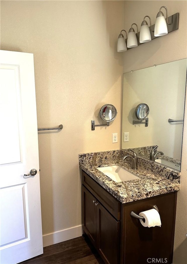 16 Petaluma Ct, Chico, CA 95926 - bathroom with vanity, baseboards, and wood finished floors