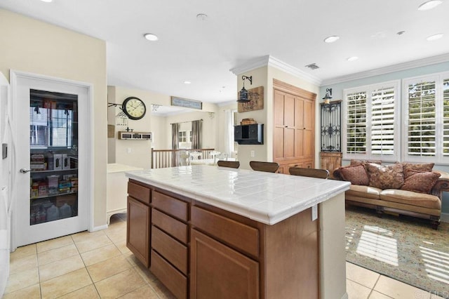 kitchen featuring light tile patterned floors, visible vents, recessed lighting, ornamental molding, and tile countertops
