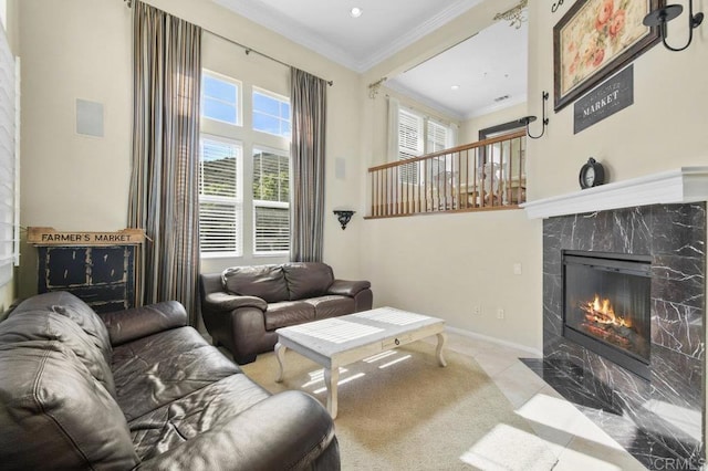 living room featuring crown molding, a high end fireplace, baseboards, recessed lighting, and tile patterned floors