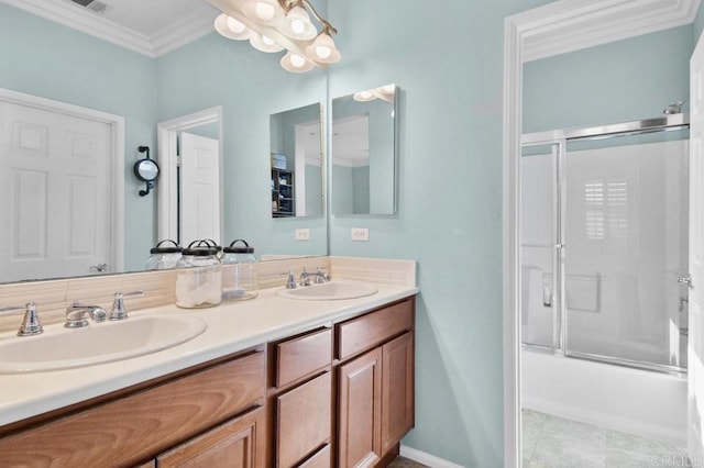 bathroom with ornamental molding, bath / shower combo with glass door, double vanity, and a sink